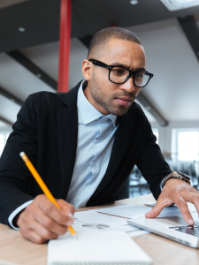 A business manager analyzes KPIs and metrics on their computer screen.
