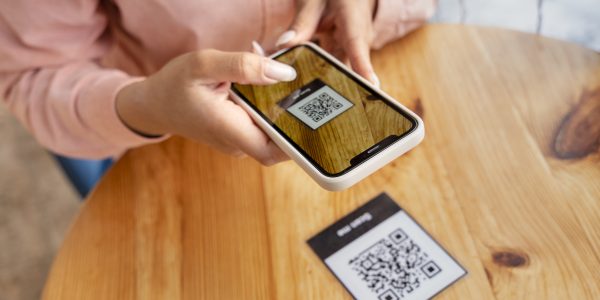 close-up-hands-holding-smartphone fake QR code, cybersecurity awareness