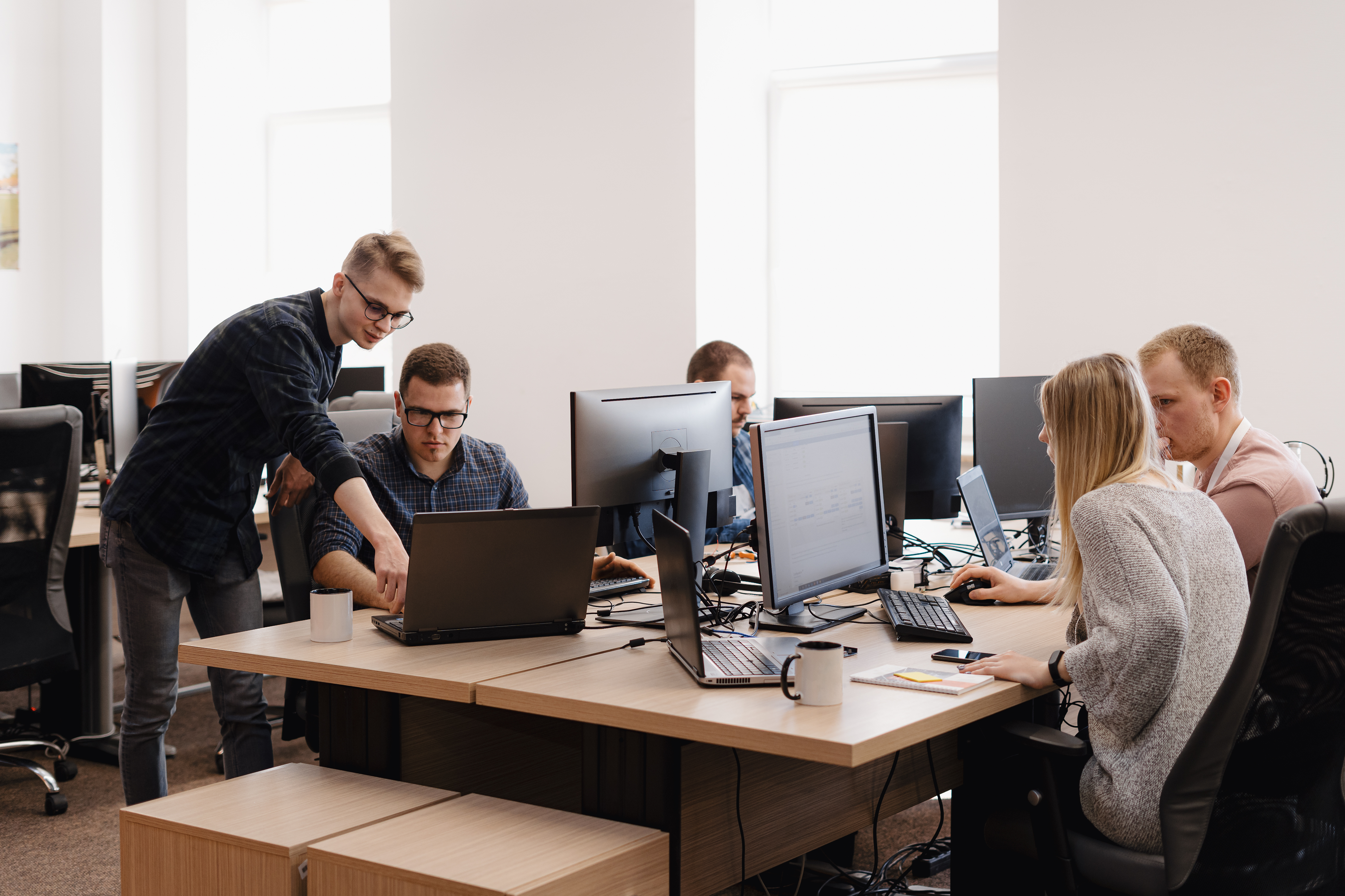 Employees working together in a bright office.