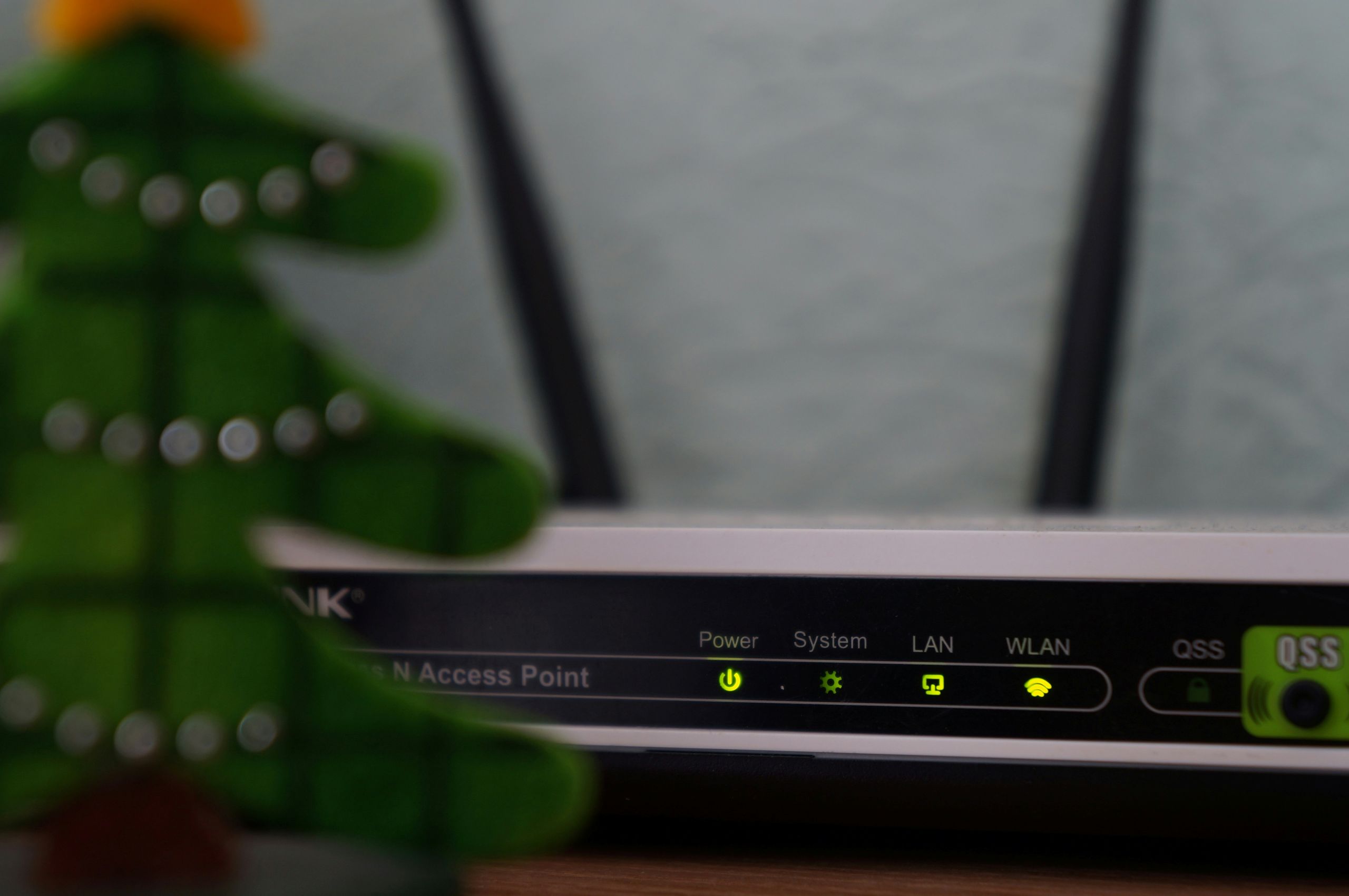 Close up of Wi-Fi router showing lit LED lights.