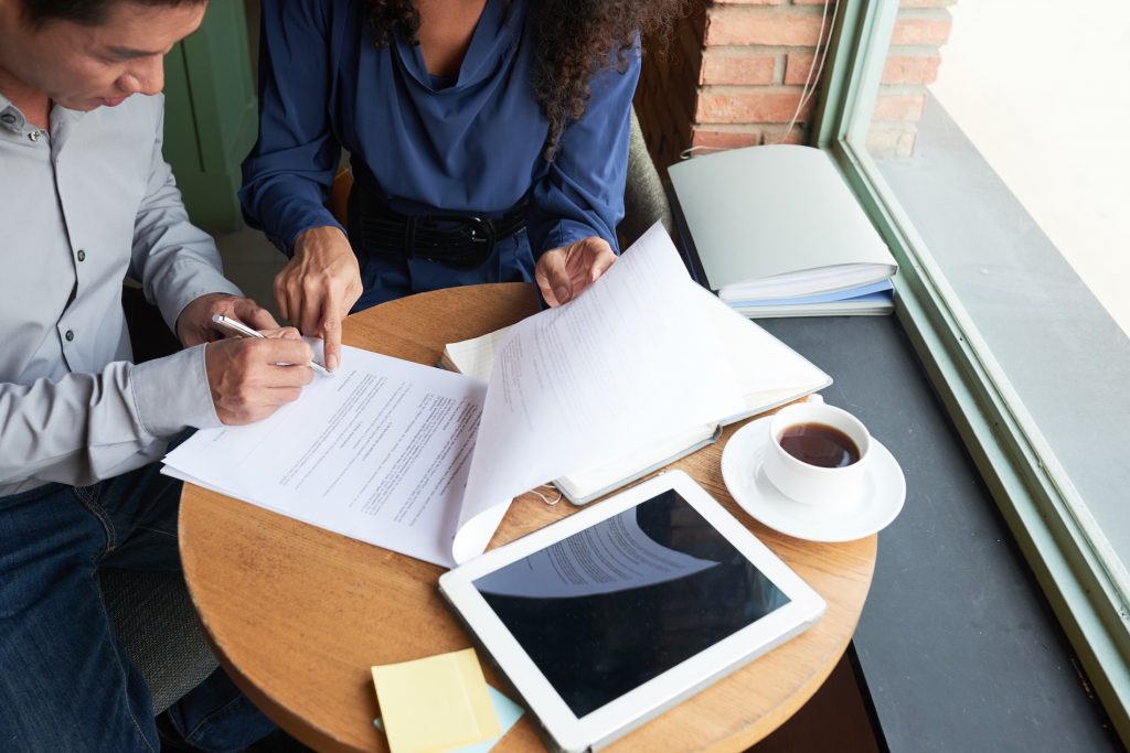 Business owners reviewing vendor contract security requirements as part of small business vendor risk management