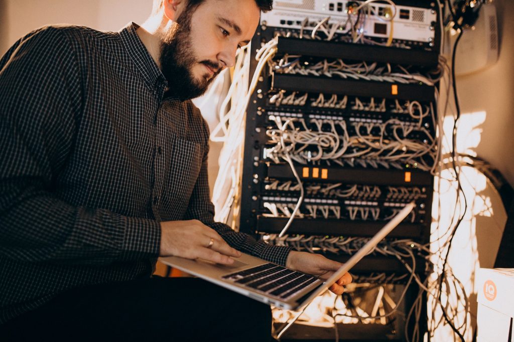 IT technician applying security patches to business network equipment as part of managed IT services maintenance