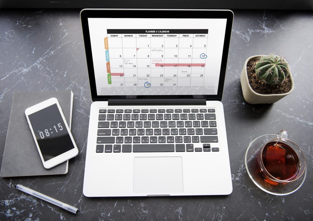 Business calendar and planner on a desk, showing where calendar phishing invites appear on an employee schedule