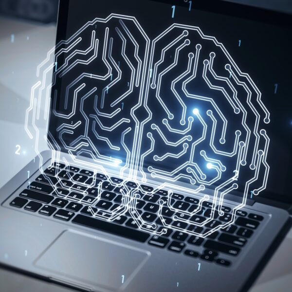 Close up of laptop computer on desktop with glowing human brain hologram on screen and blurry background. Neurology research and artificial intelligence concept. 3D Rendering